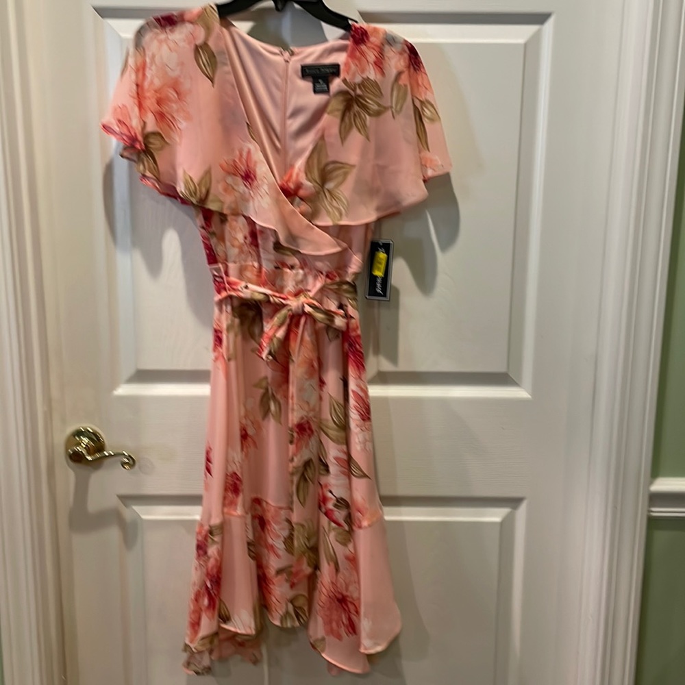 V-neck dress.  Ruffle makes flutter sleeves. Tie at waist.